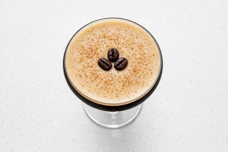 Christmas espresso martini with eggnog foam and coffee beans garnish in a cocktail glass