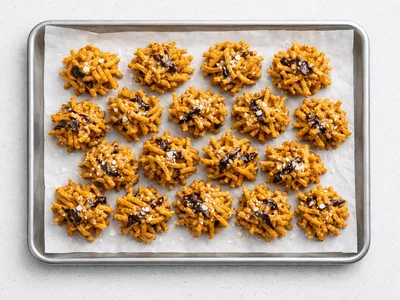 Christmas haystacks cookies on parchment, golden butterscotch chow mein noodle clusters