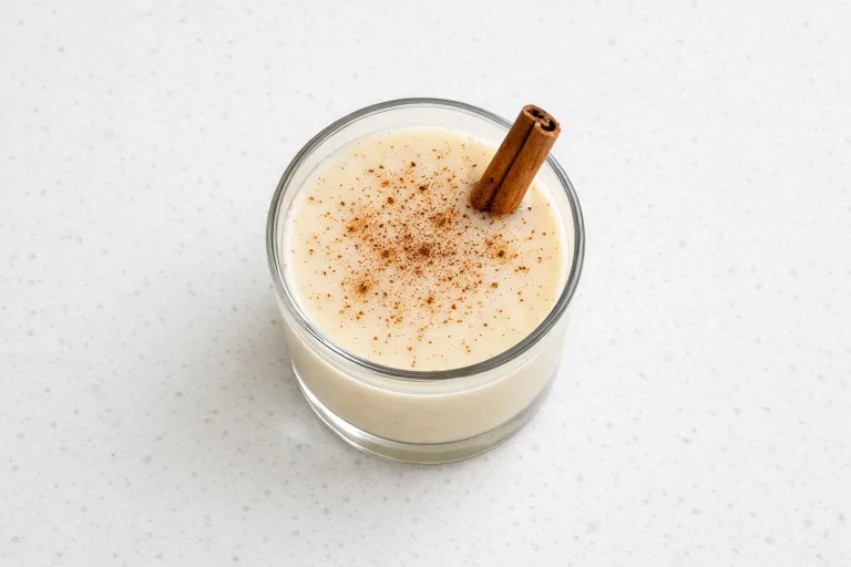 Glass of coquito Puerto Rican coconut eggnog with cinnamon and nutmeg