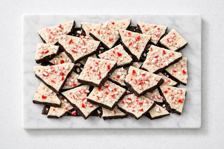 Homemade peppermint bark pieces with dark and white chocolate layers topped with crushed candy canes