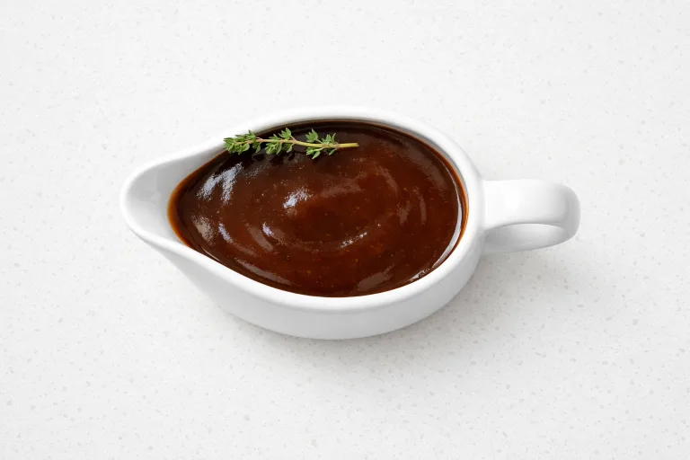 Rich Madeira Christmas gravy in a white ceramic gravy boat, deeply colored and glossy