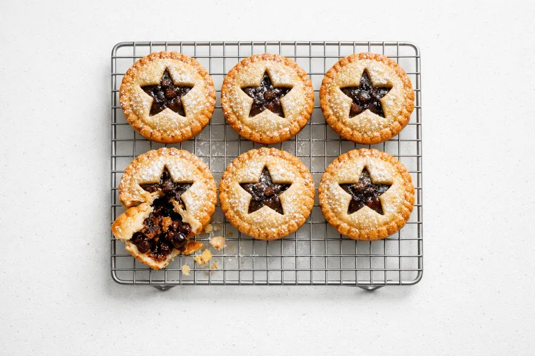 Traditional British mince pies with star-shaped pastry tops and powdered sugar dusting