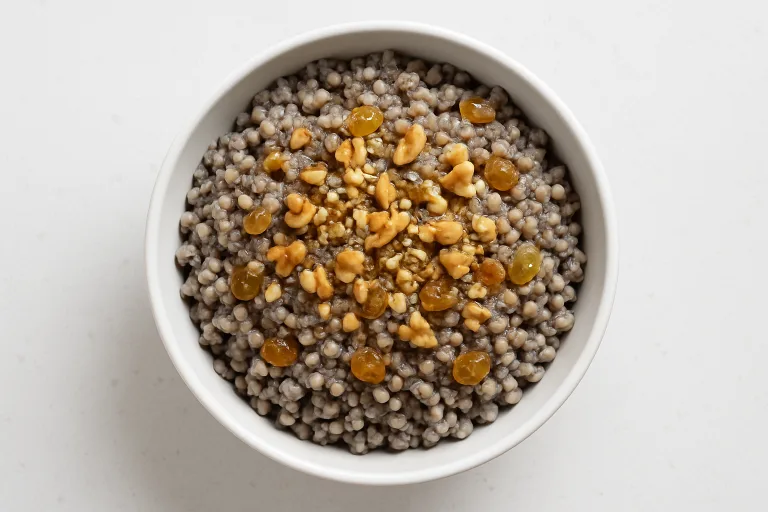 Traditional kutia in a white bowl with wheat berries, poppy seeds, walnuts, and honey drizzle